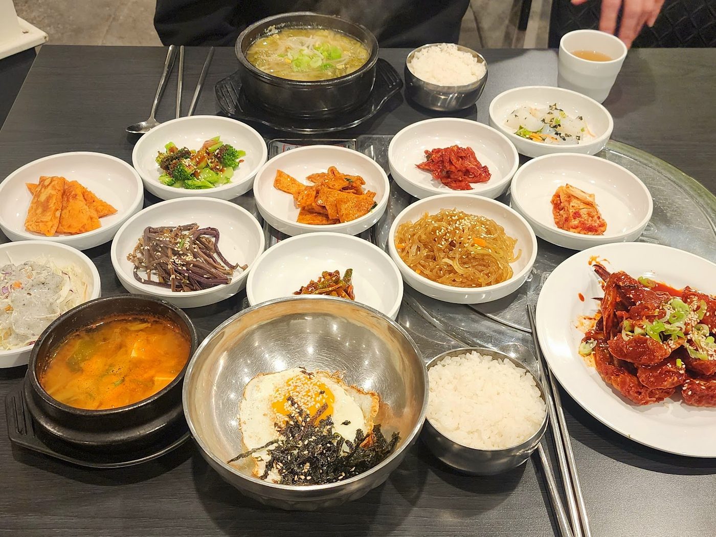 A Korean meal with soup, rice and side dishes arranged on a table